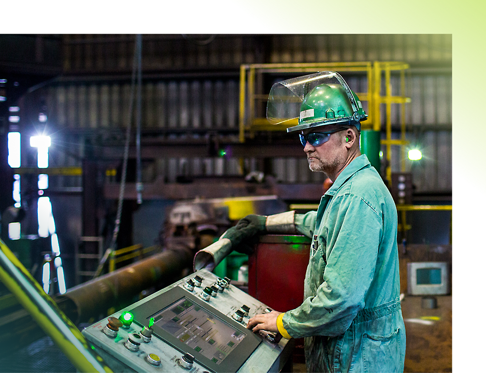 A person in a green jumpsuit and safety gear