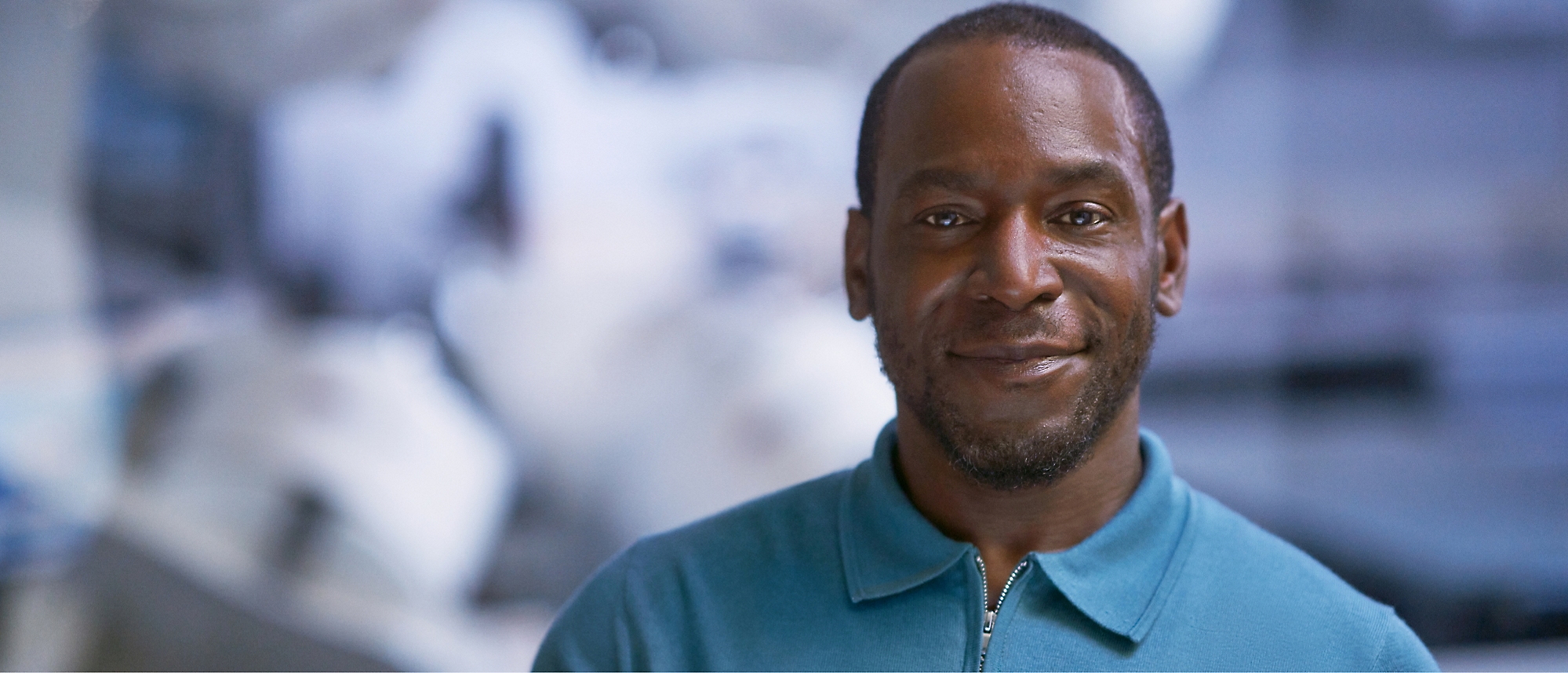 A close-up of a person in blue shirt