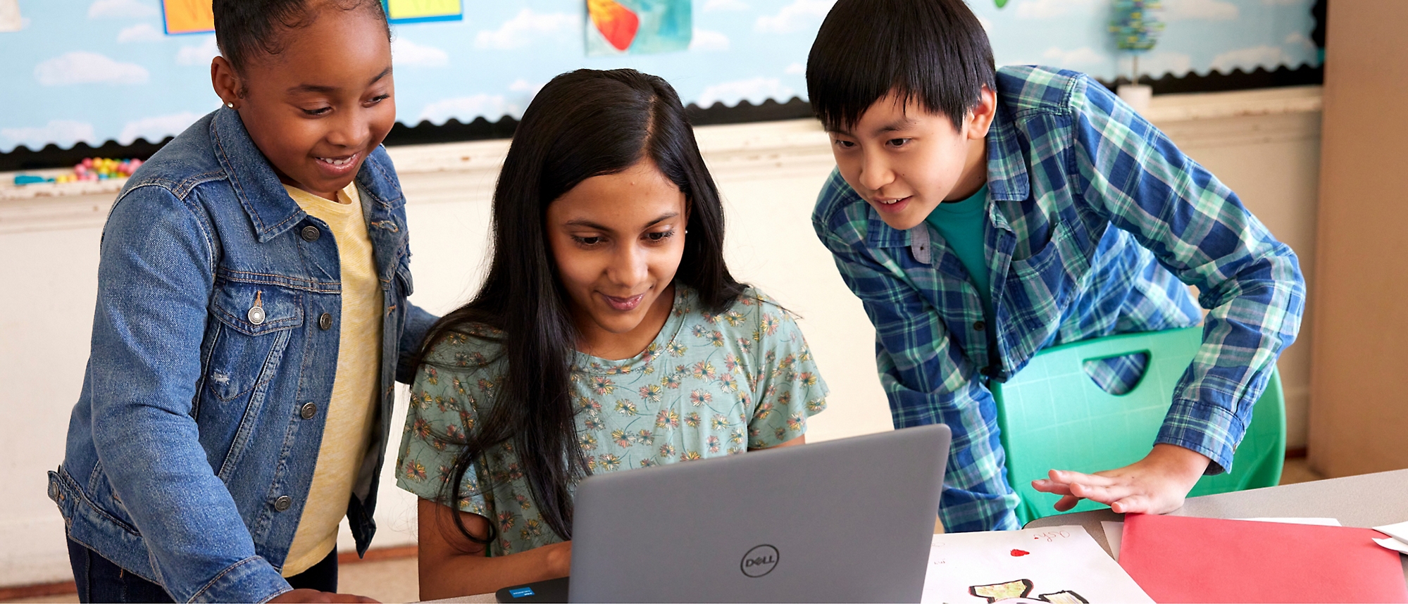 Three young person's looking at a computer