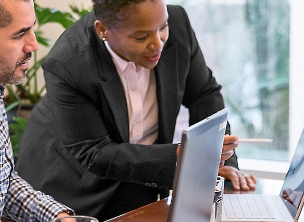 A woman looking at a laptop.