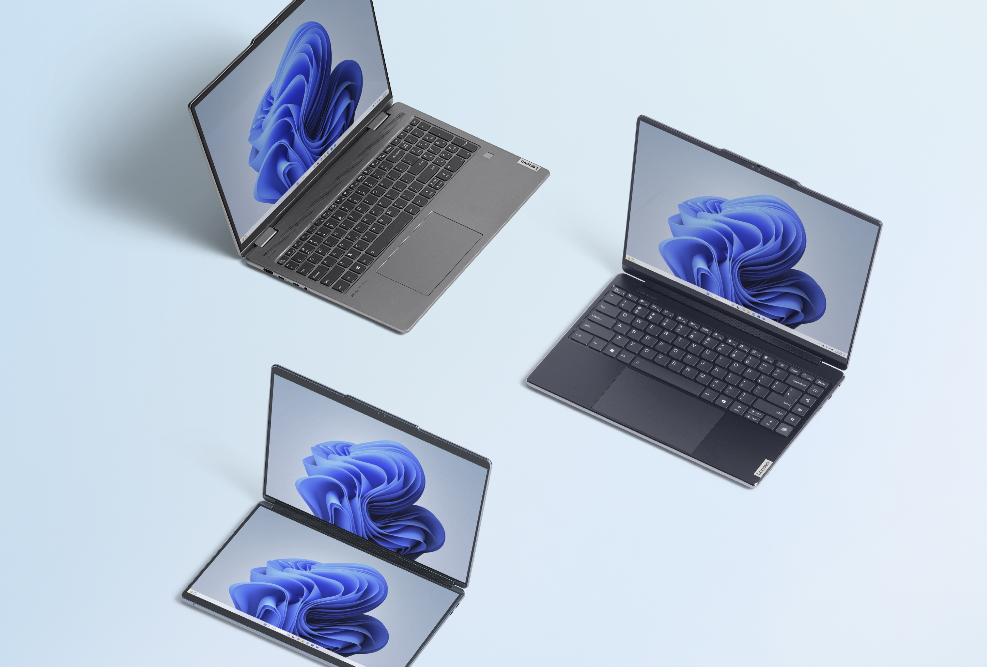 Three open devices with the blue Microsoft bloom screen on a light blue background