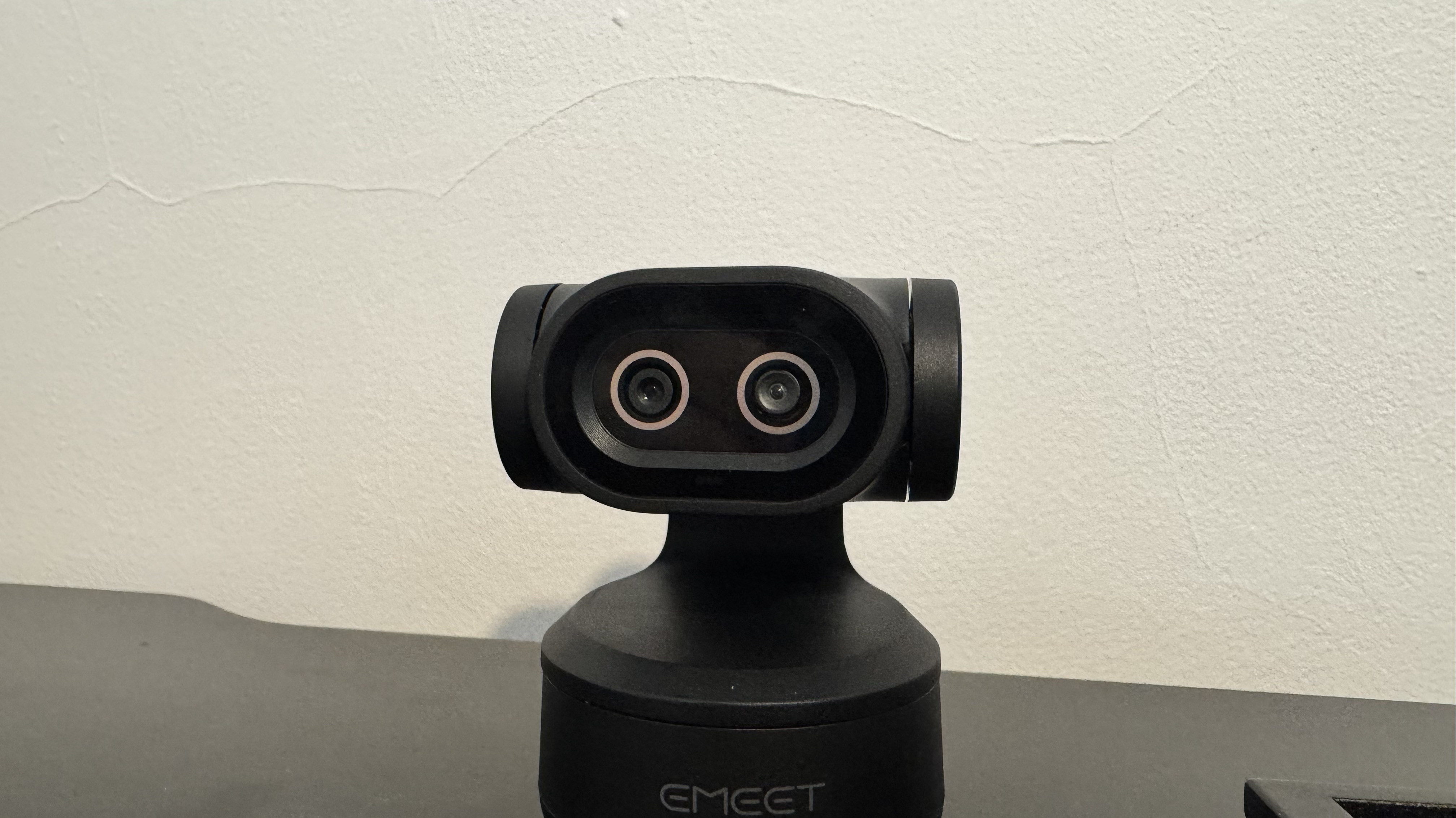 The Emeet Pixy 4K webcam on a black desk.