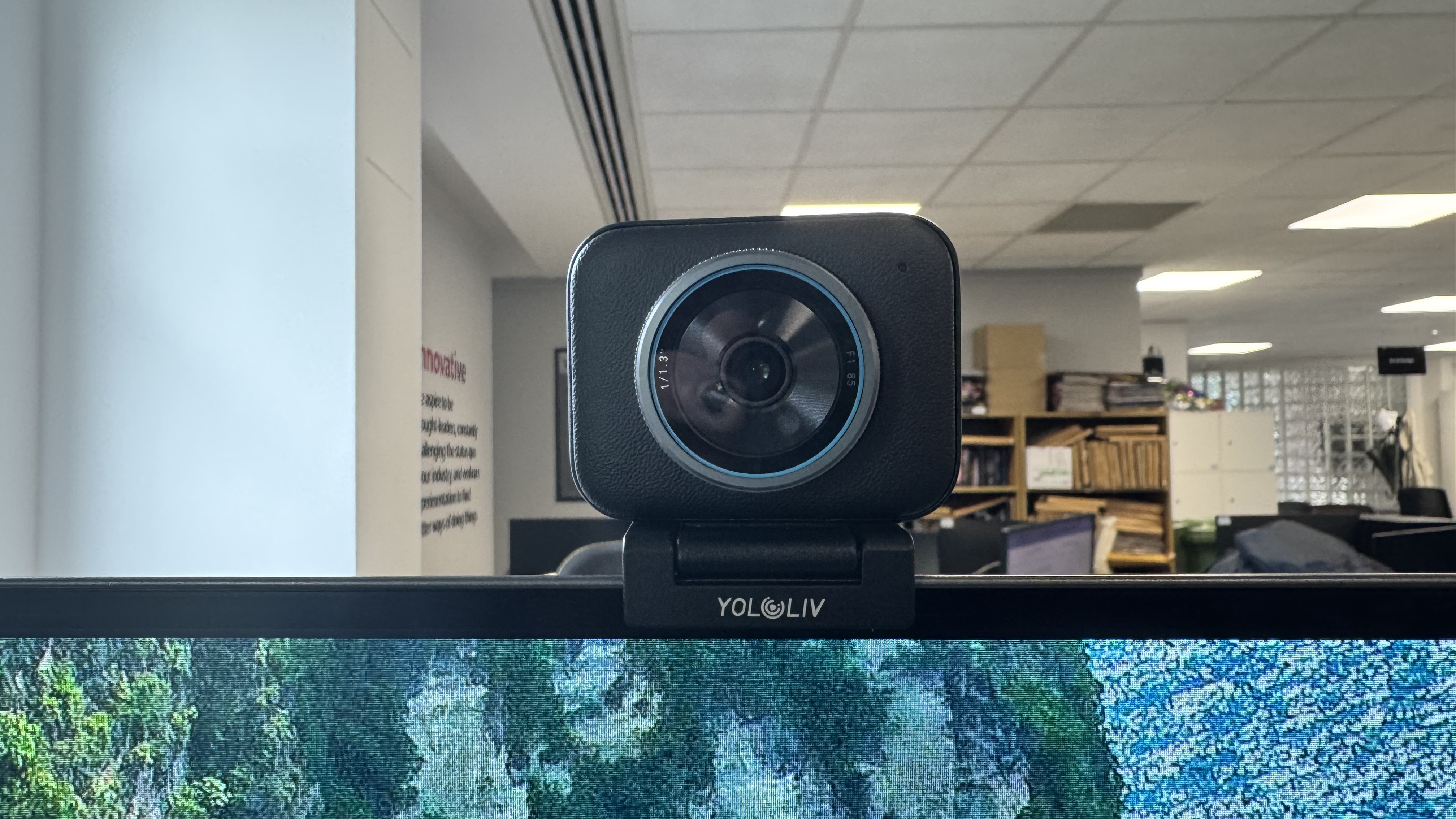 The Yololiv YoloCam S3 4K webcam from the front, on top of a monitor