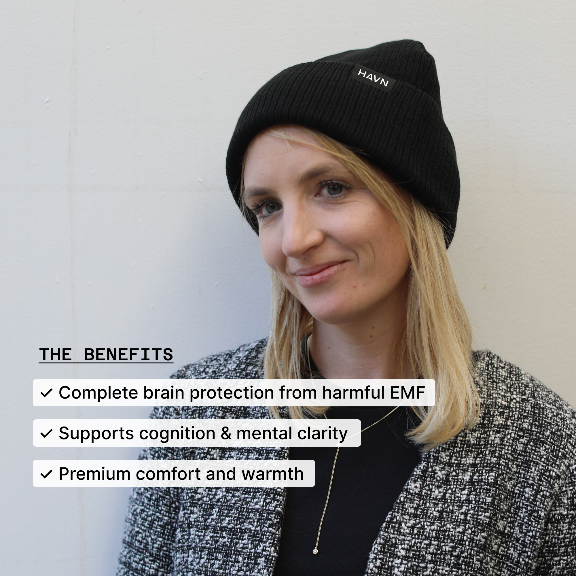 Person wearing a black beanie with text about its benefits on a light background