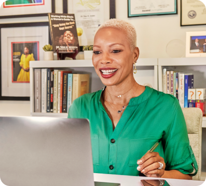 An individual smiling at their workstation.