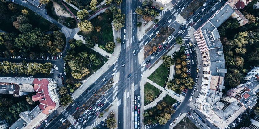Overhead photo of a traffic circle in a city.