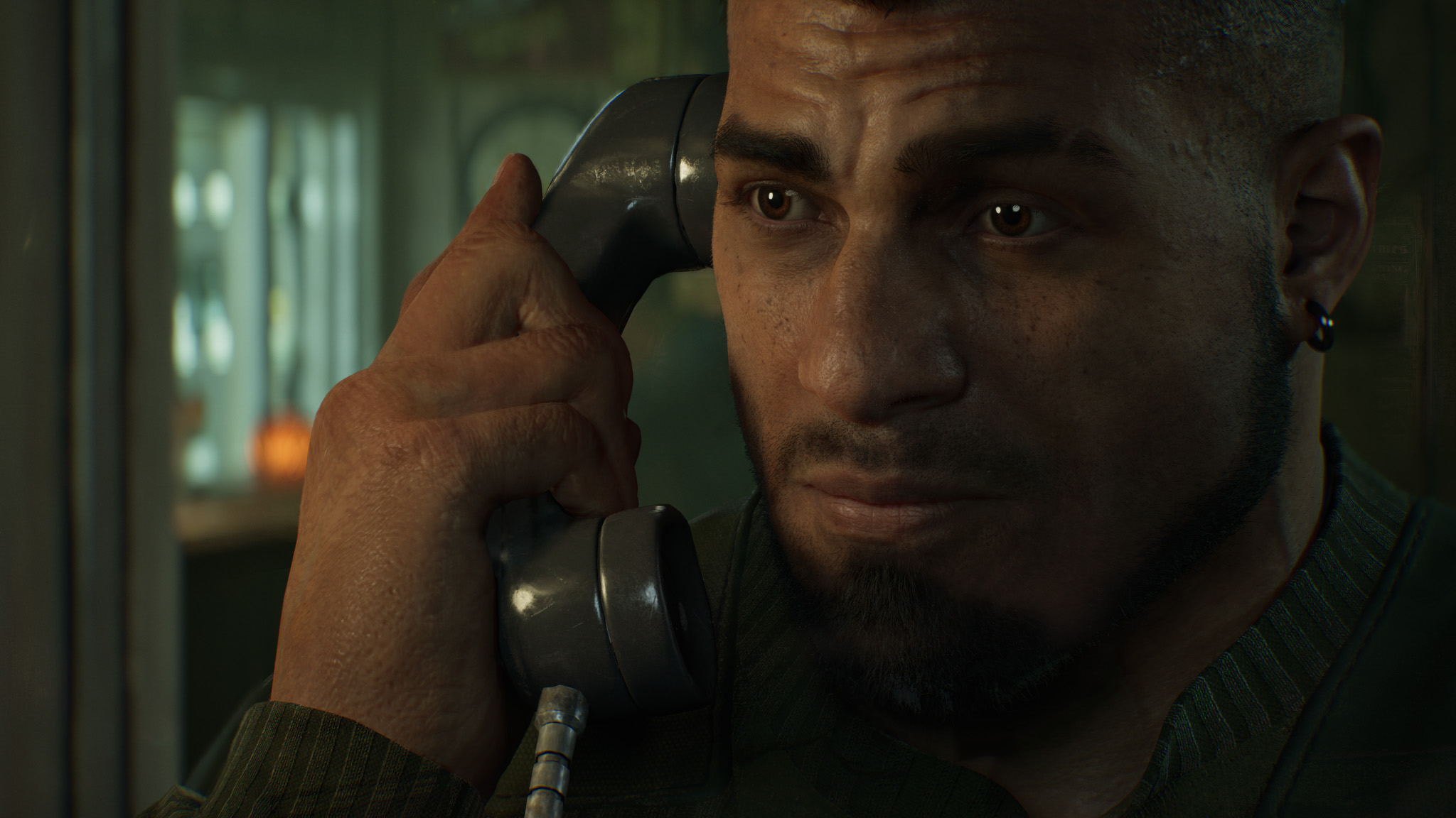 Close-up of Dom talking on the phone