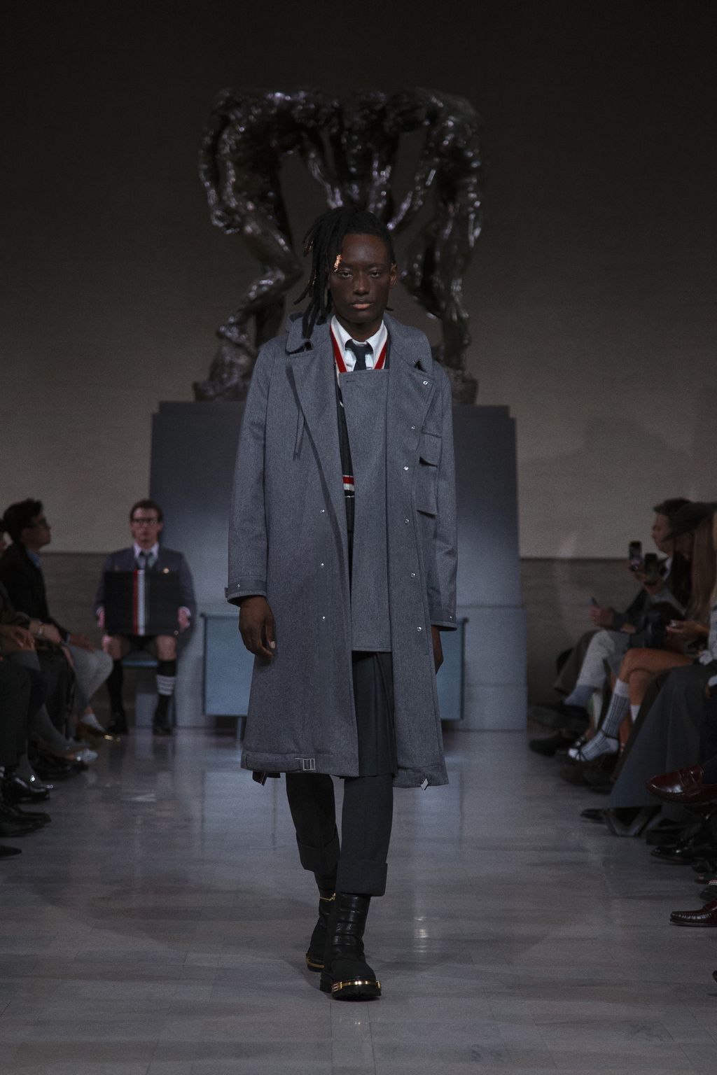 Image may contain Clothing Coat Adult Person Overcoat Accessories Formal Wear Tie Footwear Shoe and Fashion
