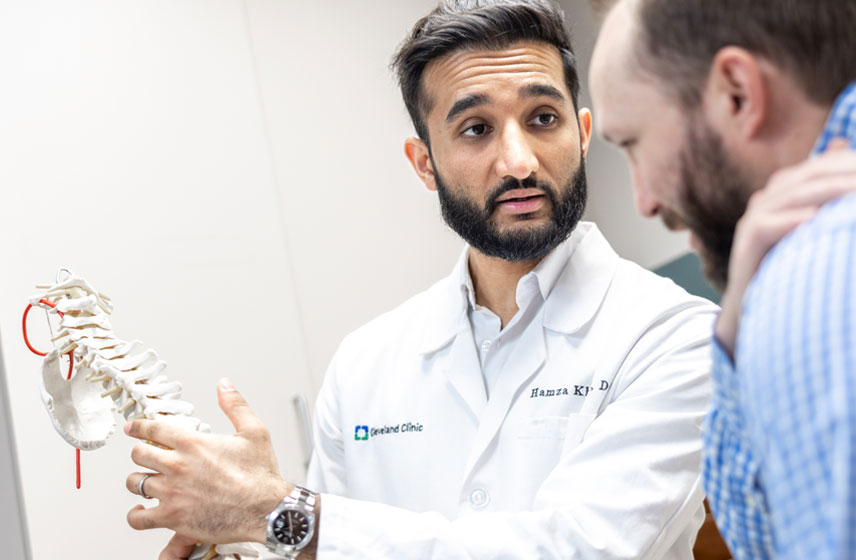 Cleveland Clinic doctor consulting a patients back pain