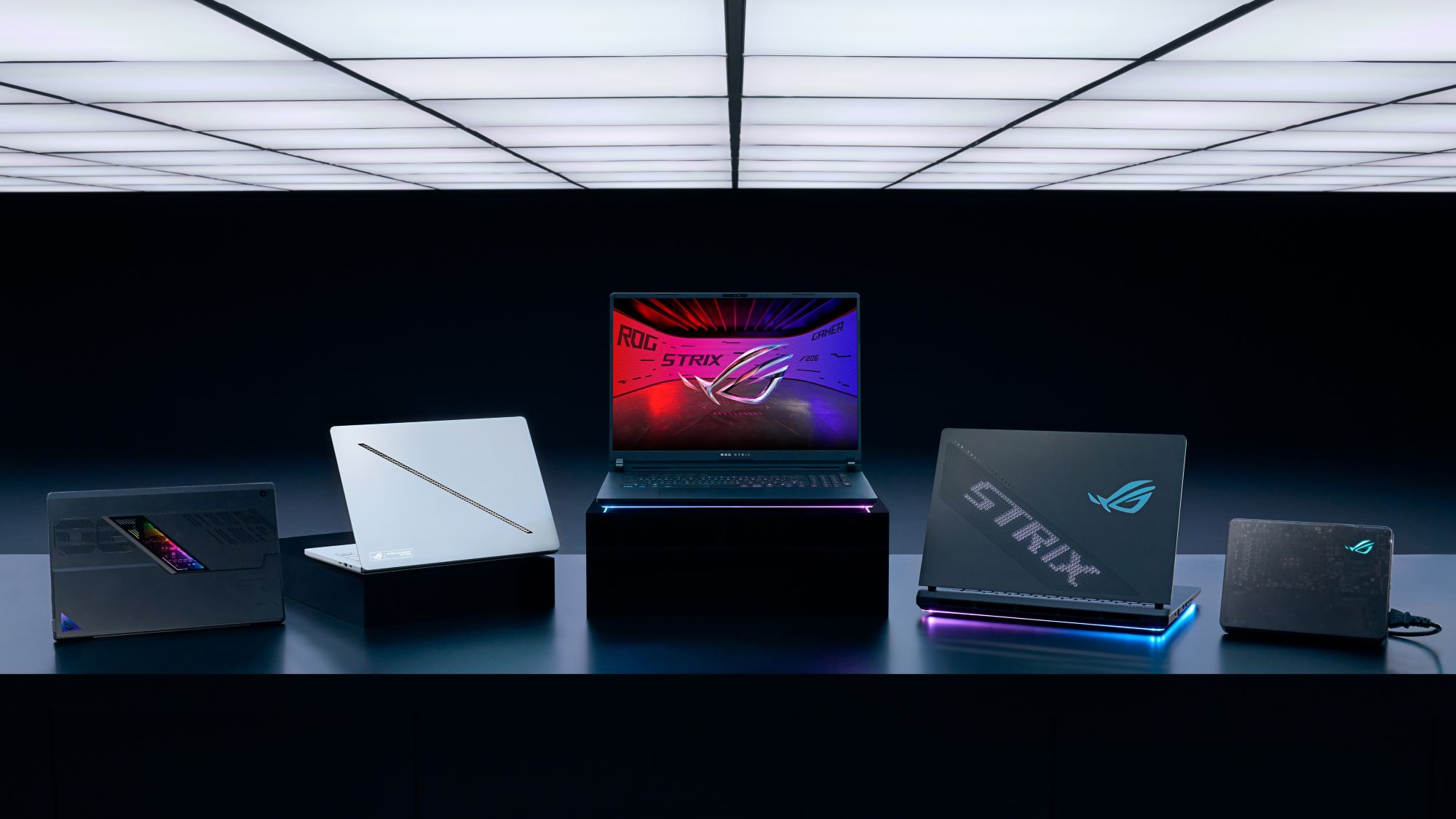 The 2025 ROG Laptop family sitting on a table under white lights
